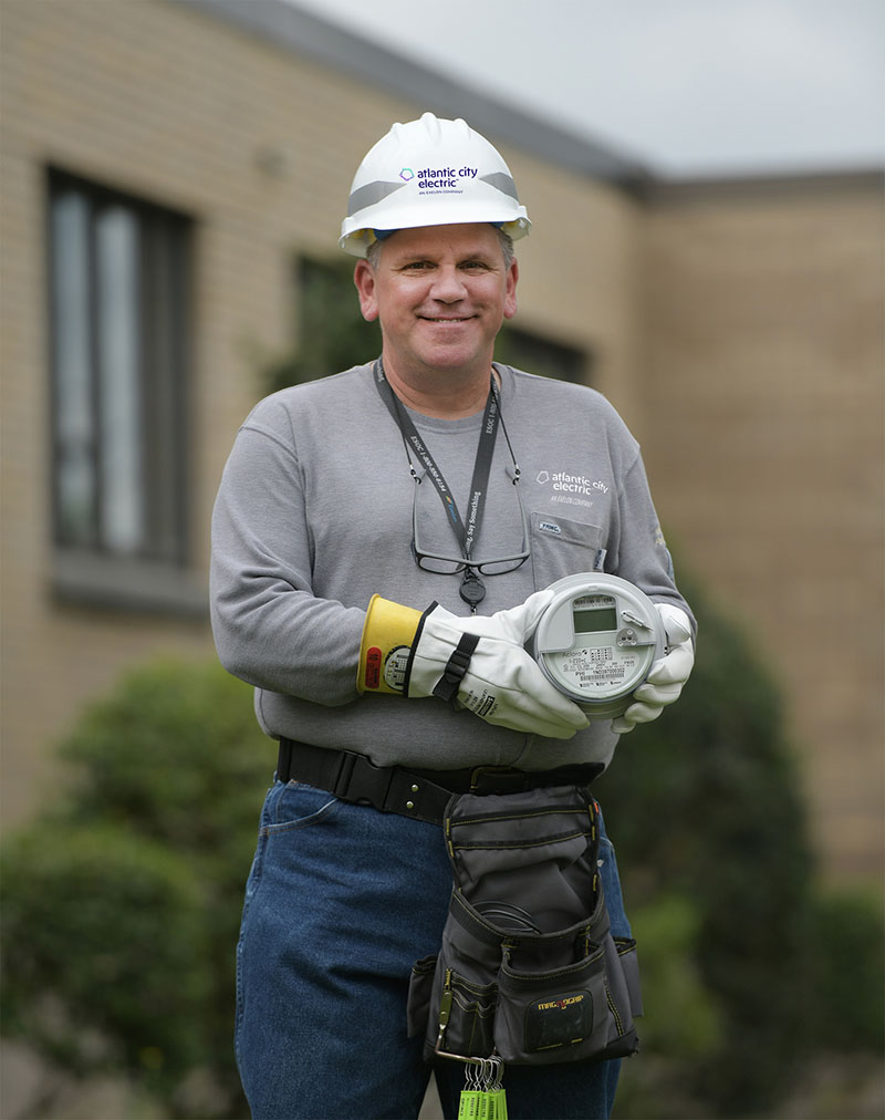 Electric Worker holding a Smart Energy Network Meter