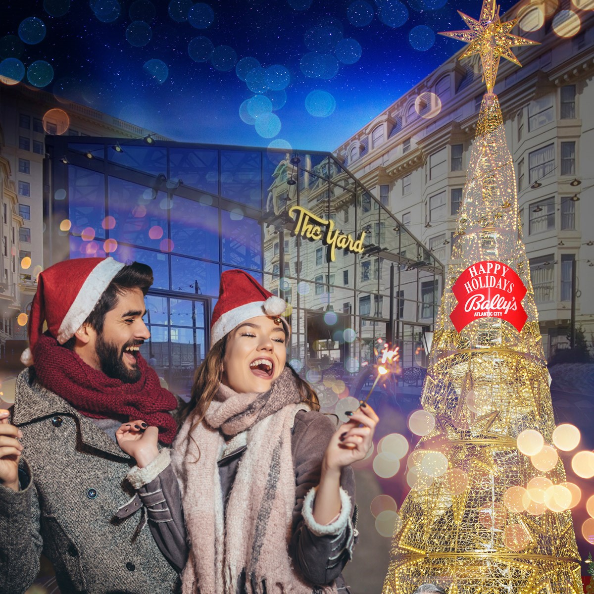 Happy Holidays from The Yard at Bally's with a couple dressed warmly stand outside next to a festive decorated Holiday Tree at Bally's Atlantic City.