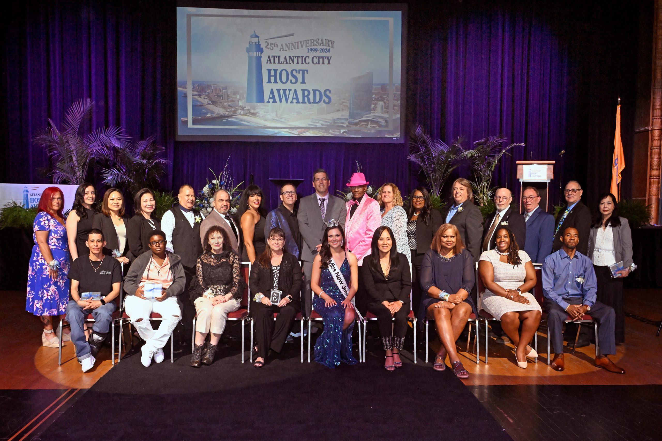 The 25th Annual Atlantic City Host Awards and Spirit of Hospitality Award was held on Wednesday, May 8, 2024, at Jim Whelan Boardwalk Hall in the Adrian Phillips Theater. Pictured here with the Host Award winners are CRDA Executive Director Eric Scheffler, CRDA Deputy Executive Director Maisha Moore, Miss New Jersey Victoria Mozitis, and Spirit of Hospitality Award Winner Scott Cronick, WOND radio personality, journalist, and co-owner of the Tennessee Avenue Beer Hall.
