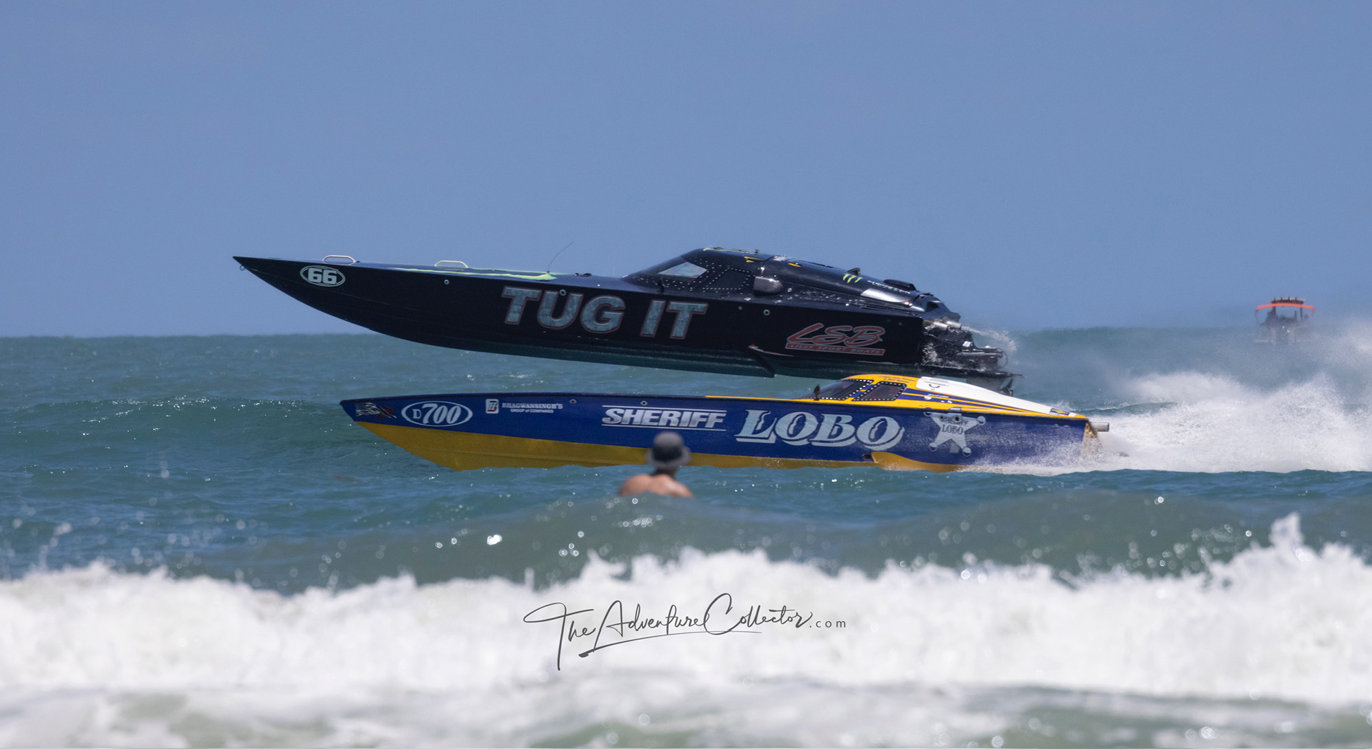 Offshore Power Boat Association Racing. Two boats go head to head in front of swimmer in ocean.